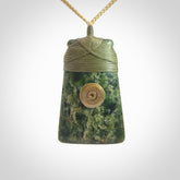 Carved from a lovely piece of local New Zealand Jade. The quality of the workmanship and design is outstanding - this is a piece you will want to wear all the time. We have suspended this from a oat cord which can be adjusted with a couple of slip knots and a fern green binding.